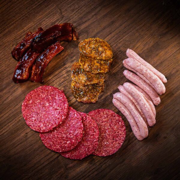 Selection of meat products including beef burgers, sausages, lemon and chilli pork steaks, and BBQ pork spare ribs